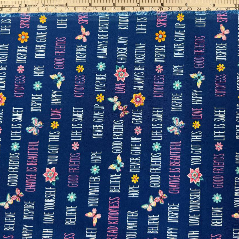 Navy blue 100% cotton quilting fabric featuring colorful inspirational words, butterflies, and flowers from the Faith & Grace collection by Kanvas Studio for Benartex.
