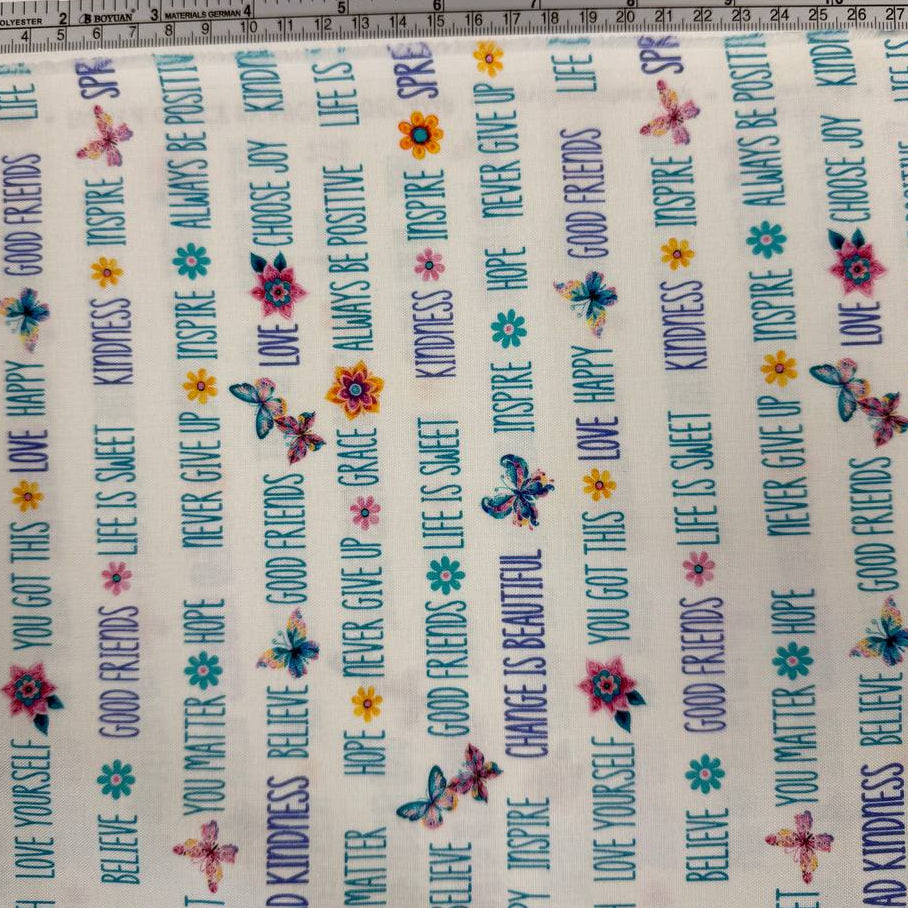 White 100% cotton quilting fabric featuring colorful inspirational words, butterflies, and flowers from the Faith & Grace collection by Kanvas Studio for Benartex.