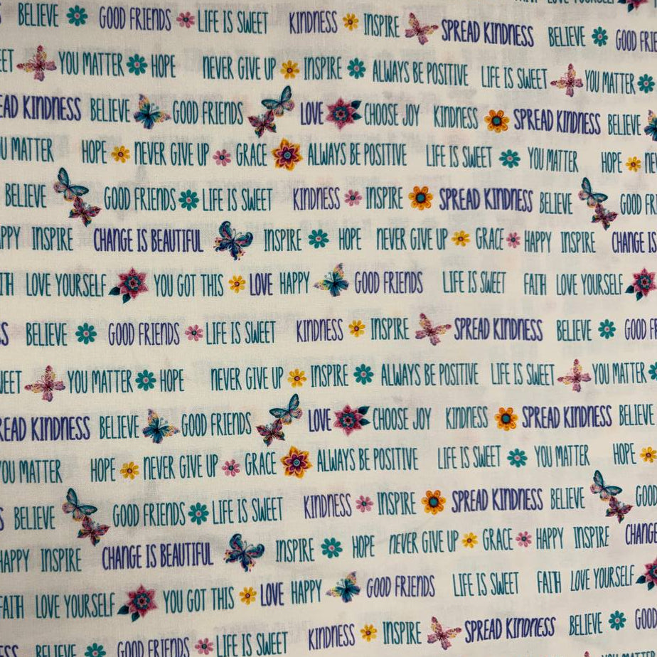 White 100% cotton quilting fabric featuring colorful inspirational words, butterflies, and flowers from the Faith & Grace collection by Kanvas Studio for Benartex.
