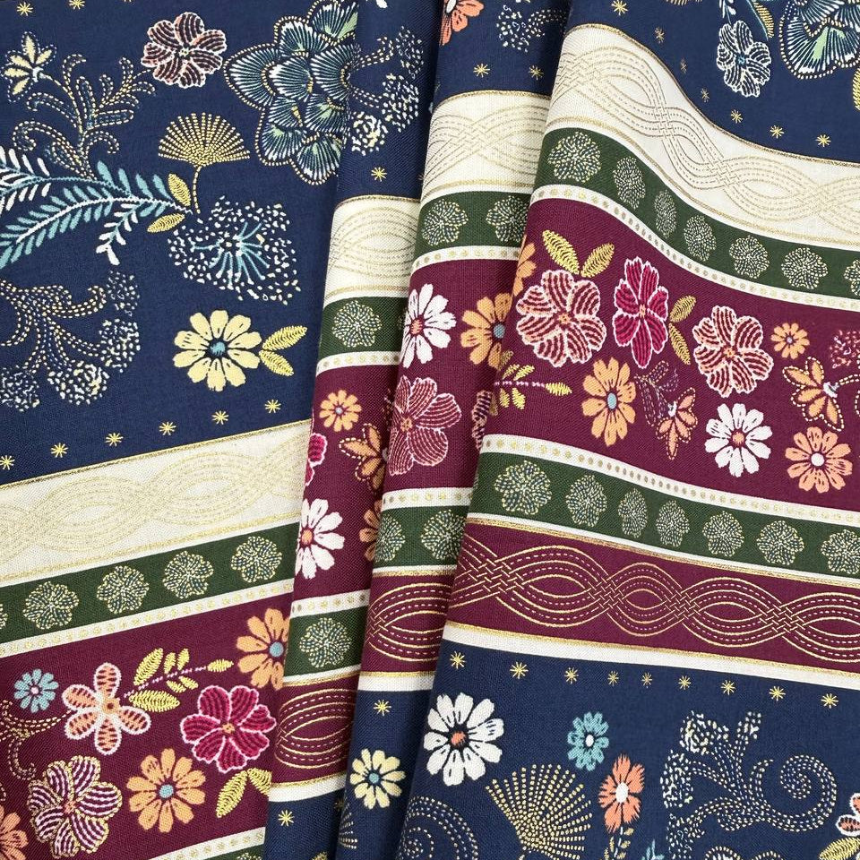 Majestic Garden Metallic Border Stripe quilting cotton by Kanvas Studio featuring decorative floral border stripes with metallic gold accents on a navy background.