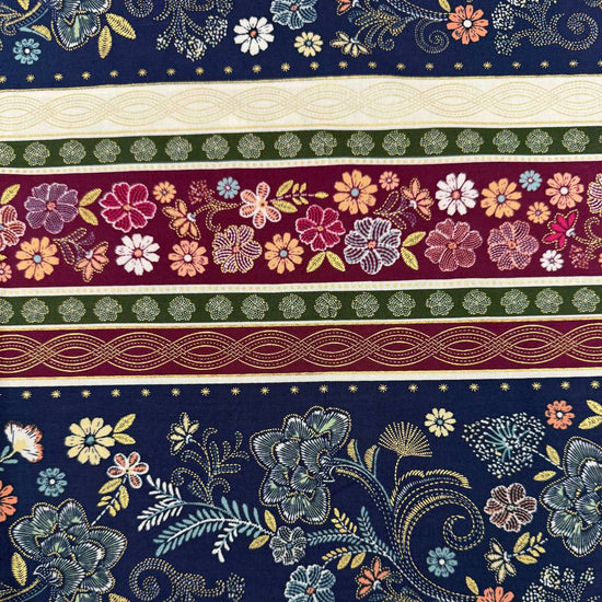 Majestic Garden Metallic Border Stripe quilting cotton by Kanvas Studio featuring decorative floral border stripes with metallic gold accents on a navy background.