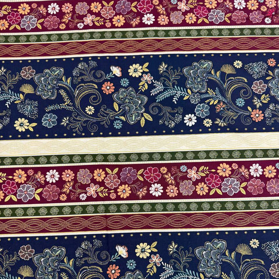 Majestic Garden Metallic Border Stripe quilting cotton by Kanvas Studio featuring decorative floral border stripes with metallic gold accents on a navy background.