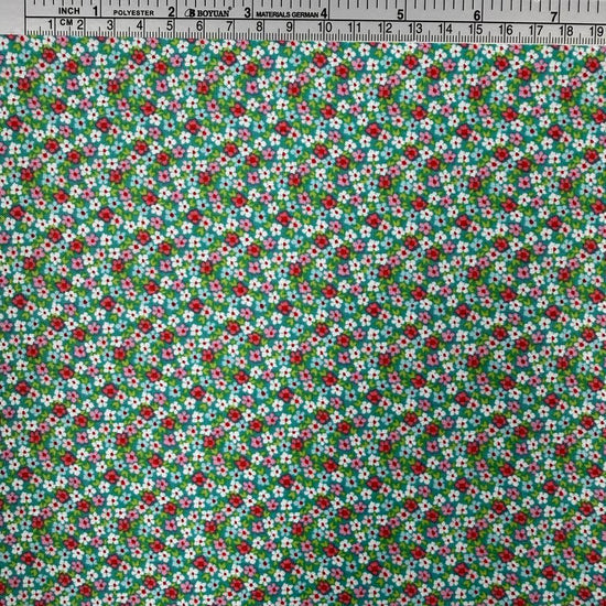 Smitten Chicken Flower Patch quilting cotton fabric by Poppie Cotton featuring tiny red, pink, and white flowers with green foliage scattered across a soft aqua background.