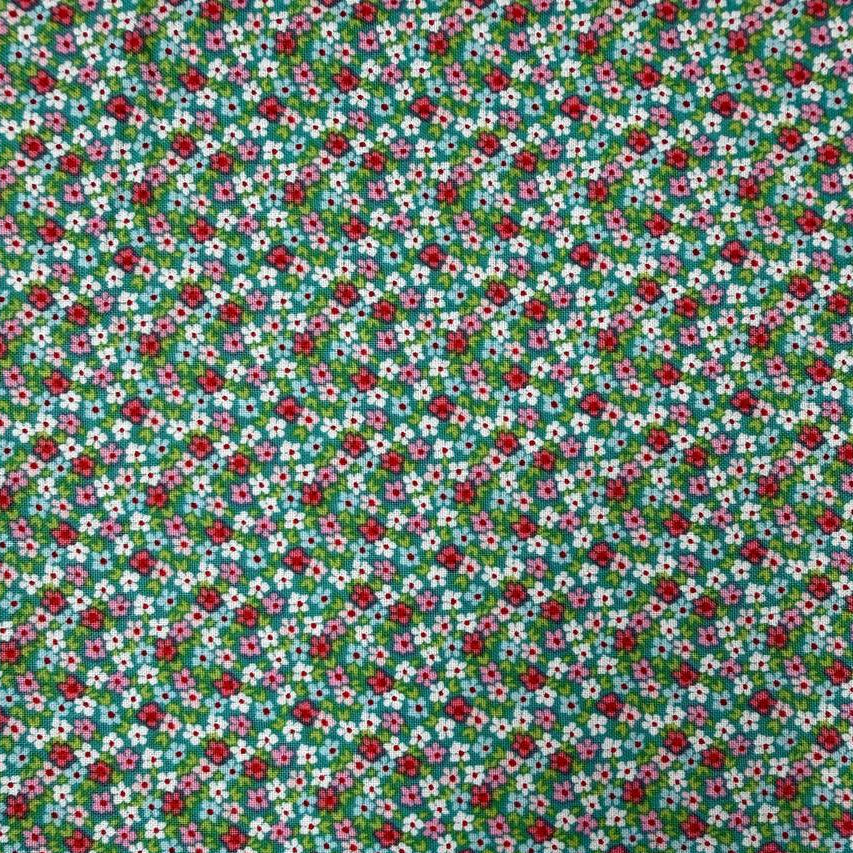 Smitten Chicken Flower Patch quilting cotton fabric by Poppie Cotton featuring tiny red, pink, and white flowers with green foliage scattered across a soft aqua background.