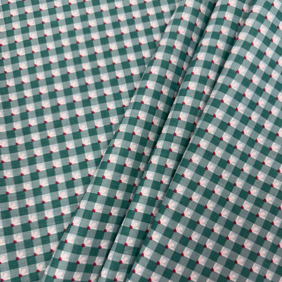 Smitten Chicken Check-A-Roo quilting cotton fabric by Poppie Cotton featuring a small gingham check with tiny white floral accents, available in Aqua and Pink.