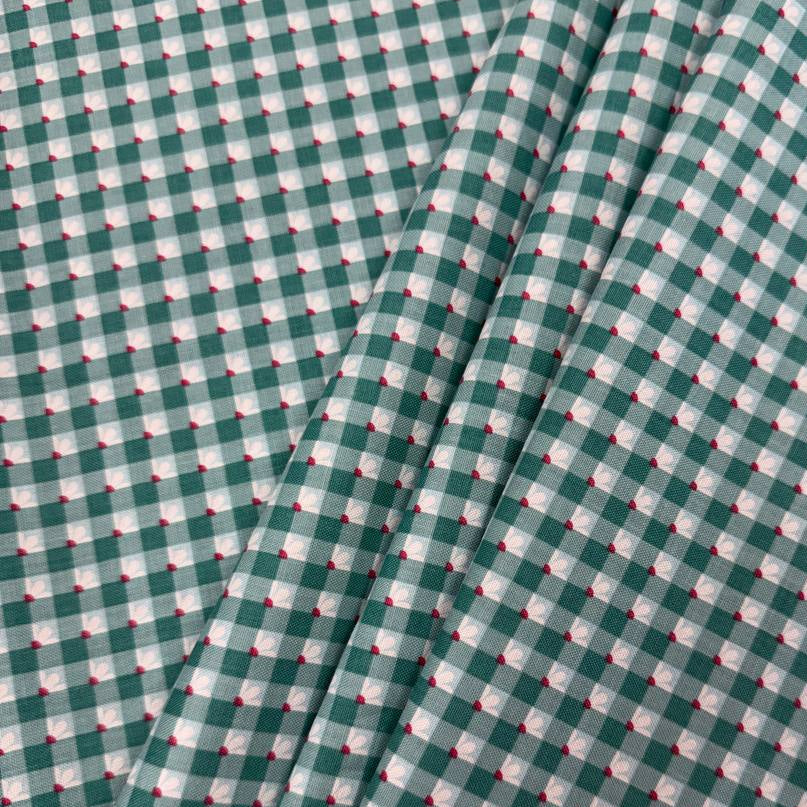 Smitten Chicken Check-A-Roo quilting cotton fabric by Poppie Cotton featuring a small gingham check with tiny white floral accents, available in Aqua and Pink.