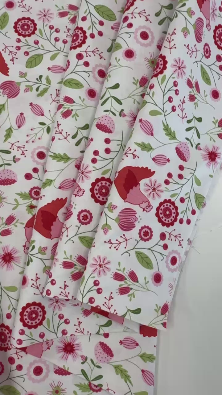 Smitten Chicken Hen House Floral quilting cotton fabric by Poppie Cotton featuring pink and red hens surrounded by flowers, berries, and green foliage on a white background.