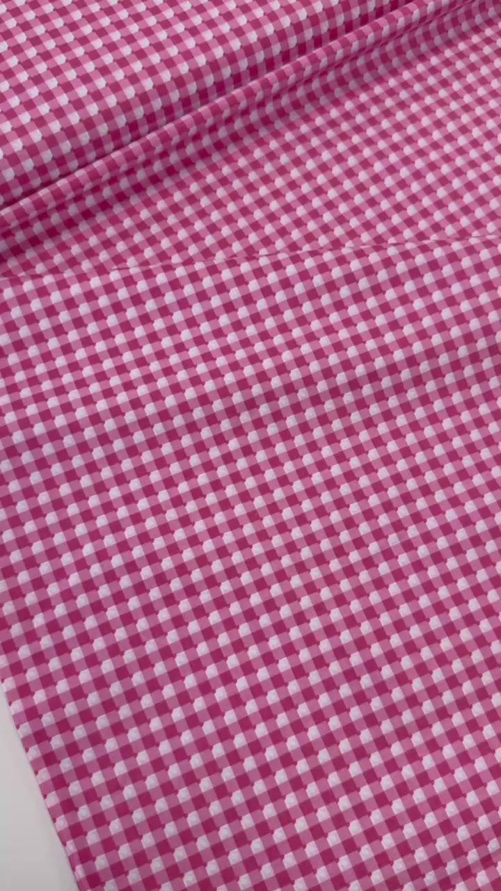 Smitten Chicken Check-A-Roo quilting cotton fabric by Poppie Cotton featuring a small gingham check with tiny white floral accents, available in Aqua and Pink.