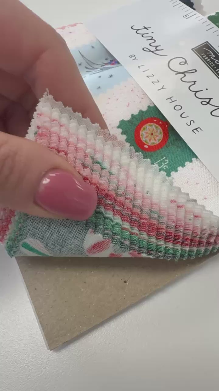 Tiny Christmas charm pack fabric bundle by Lizzy House for Moda Fabrics with 42 precut 5 inch cotton quilting squares featuring Christmas themed prints