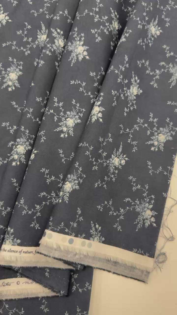 Breathtaking Blues Midnight 100% cotton fabric by 3 Sisters for Moda Fabrics featuring cream floral vine motifs on a deep blue background.