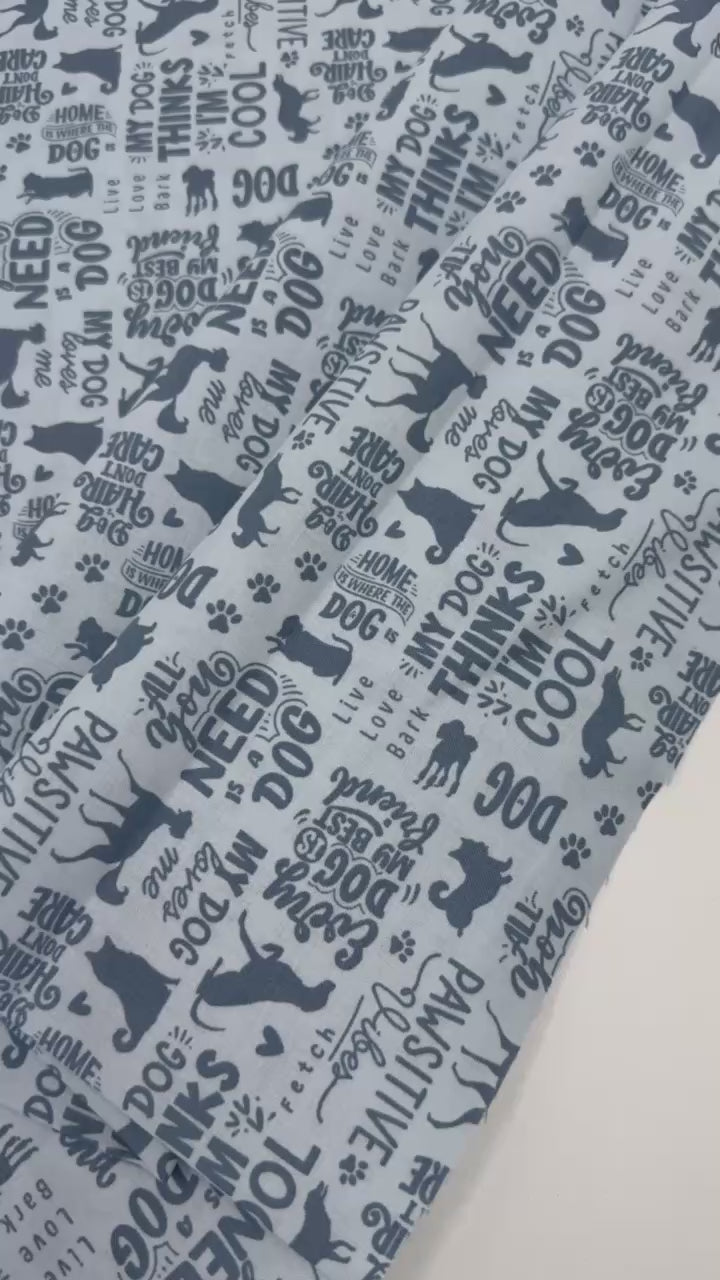Always By My Side Blue 100% cotton fabric featuring dog silhouettes, paw prints and playful dog-themed phrases on a light background, product code 91328-40.