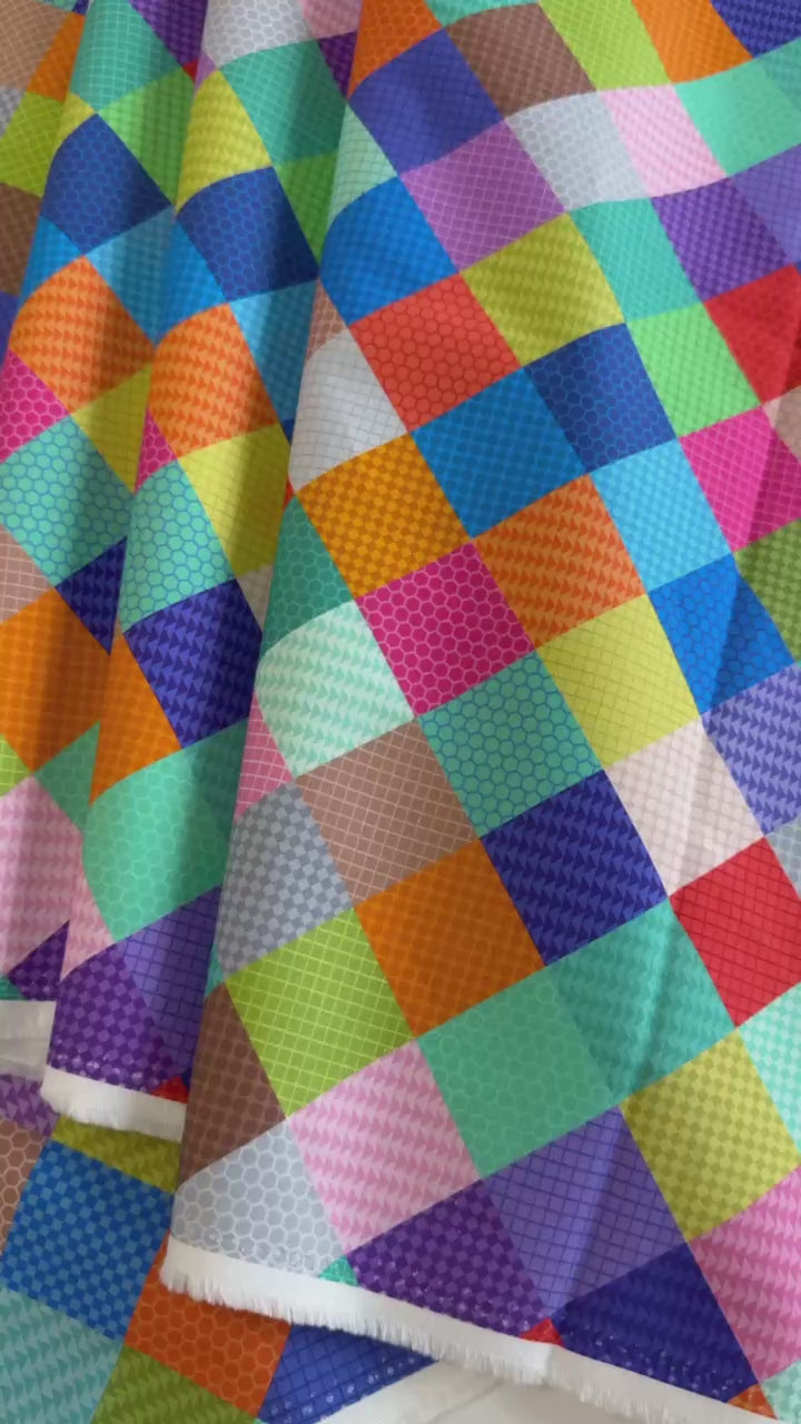Colorful patchwork geometric quilting cotton fabric from the Animal Alphabet collection by Lewis & Irene, featuring multicolored square blocks on 100% cotton.