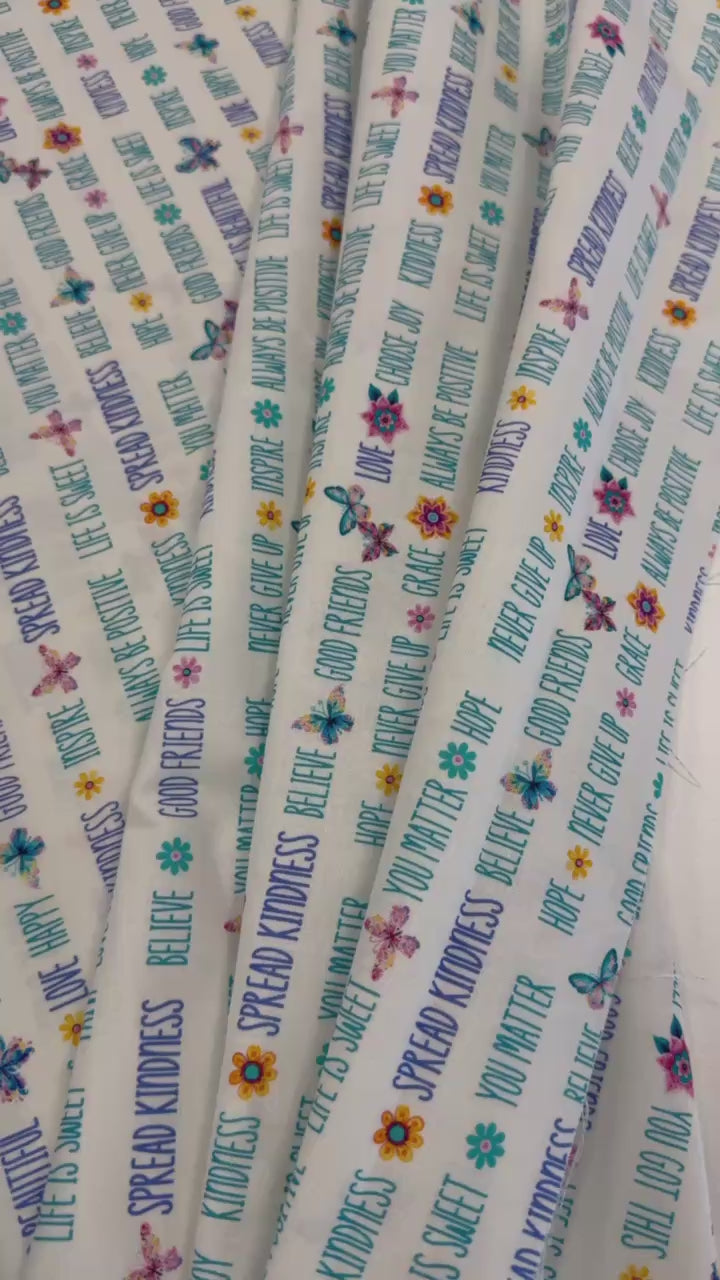 White 100% cotton quilting fabric featuring colorful inspirational words, butterflies, and flowers from the Faith & Grace collection by Kanvas Studio for Benartex.