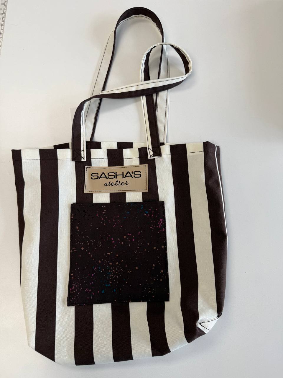 

**Handmade striped canvas tote bag with front and back exterior pockets, durable shoulder straps, and Sasha's Atelier label. Proudly made in Canada, 